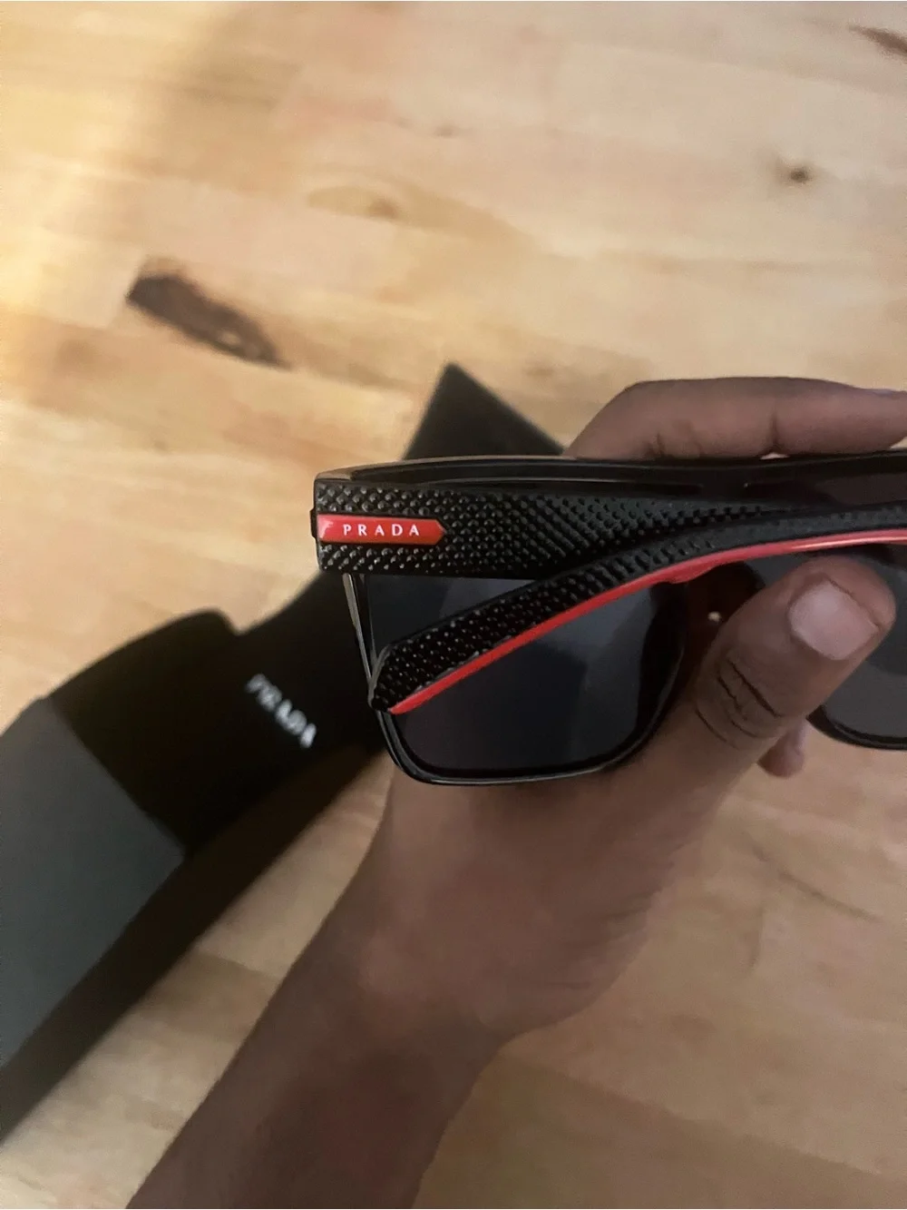 Prada Black Sunglasses with Subtle Red Accents